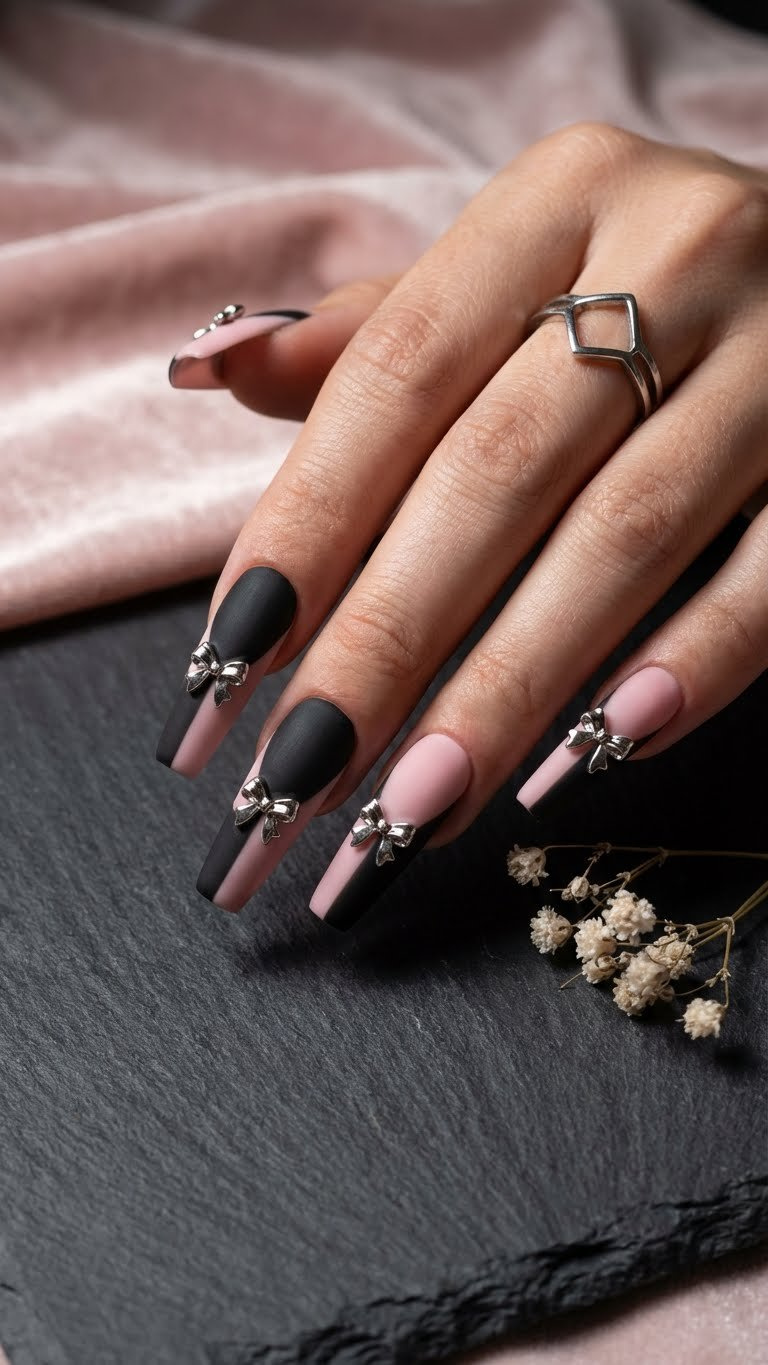 Unique long coffin nails with matte black & soft pink color block, accented by delicate silver metallic bows for Valentine's.