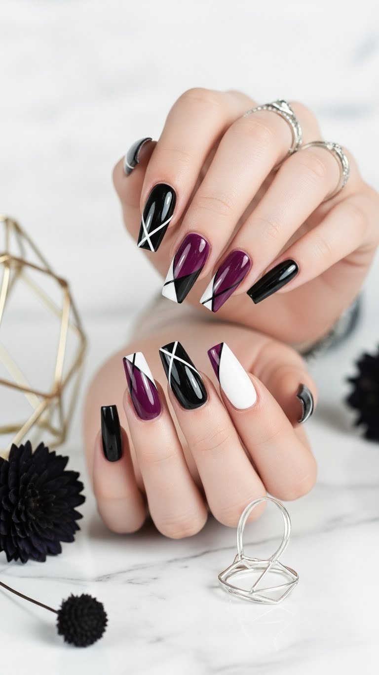 Coffin nails featuring glossy black geometric designs with purple accents and negative space