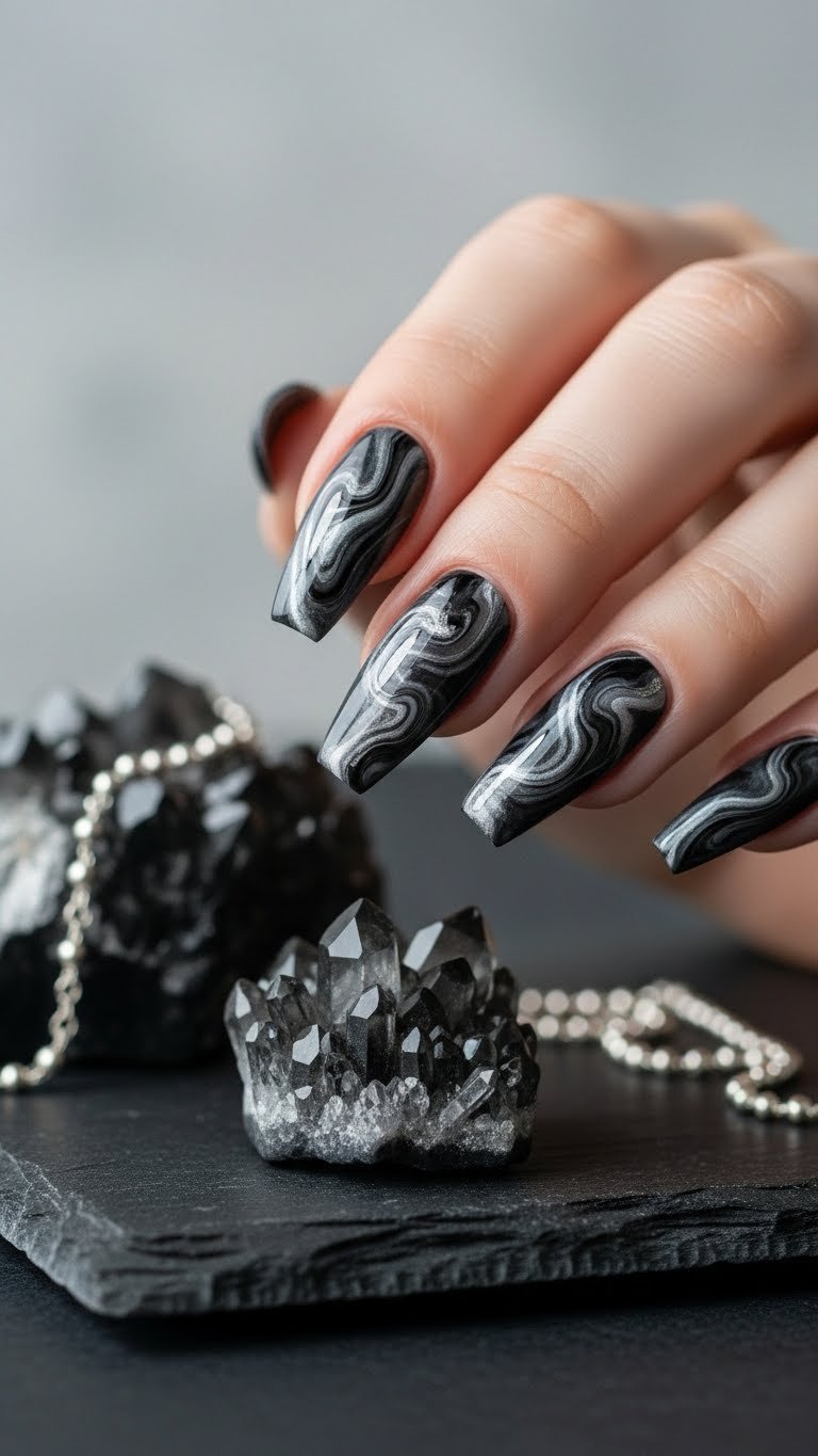 Coffin nails featuring smoky grey and black marbling with silver accents on dark slate surface